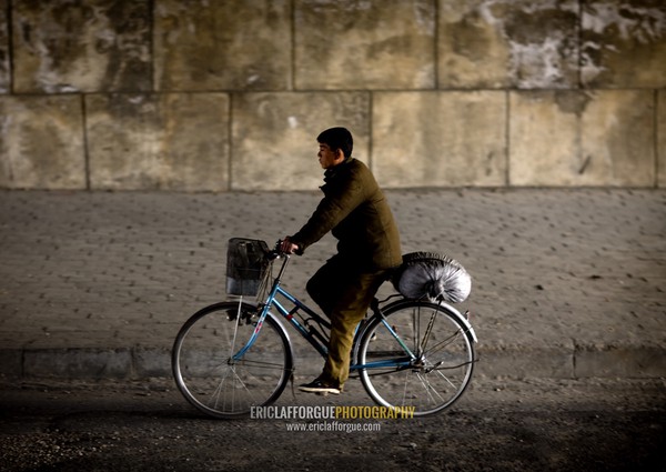 North Korean man riding a bicycle in a tunnel, Pyongan Province, Pyongyang, North Korea