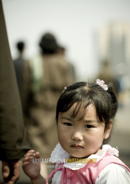 North Korean little girl holding the hand of her father, Pyongan Province, Pyongyang, North Korea