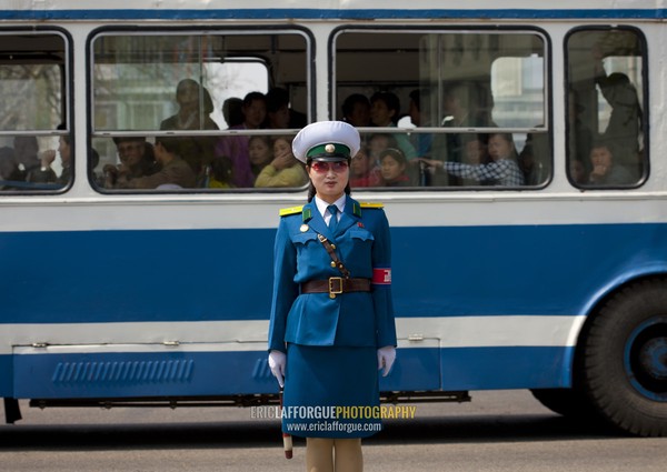 North Korean traffic security officer in blue uniform in the street, Pyongan Province, Pyongyang, North Korea