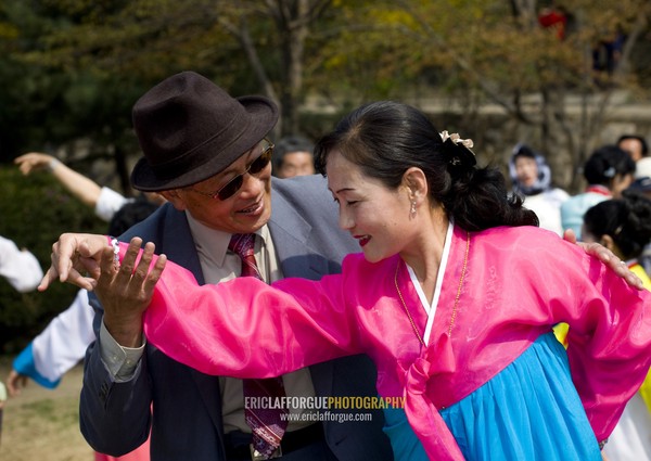 North Korean people dancing in a park for the day of the sun which is the birth anniversary of Kim Il-sung, Pyongan Province, Pyongyang, North Korea