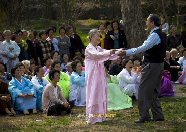 North Korean people dancing in a park for the day of the sun which is the birth anniversary of Kim Il-sung, Pyongan Province, Pyongyang, North Korea