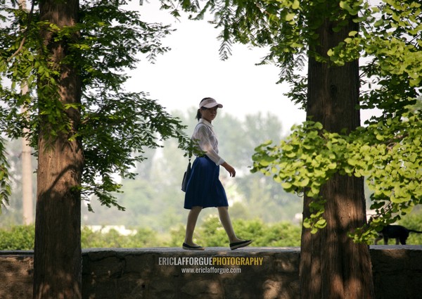 North Korean teenage girl walking in a park, North Hwanghae Province, Kaesong, North Korea