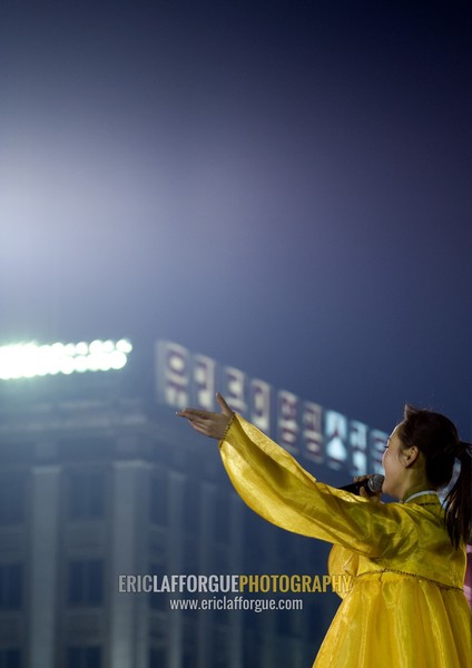 North Korean singer during a mass dance to celebrate april 15 the birth anniversary of Kim Il-sung on Kim il Sung square, Pyongan Province, Pyongyang, North Korea