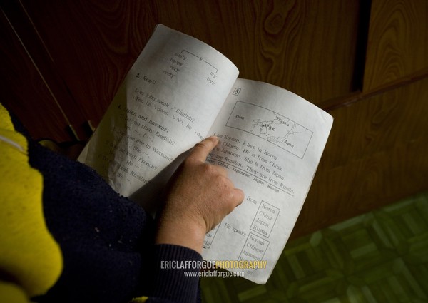 North Korean girl reading an english lesson book, Kangwon Province, Chonsam Cooperative Farm, North Korea