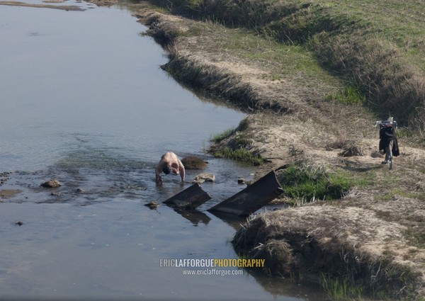 North Korean man having a bath in a cold river in the countryside, Kangwon Province, Wonsan, North Korea