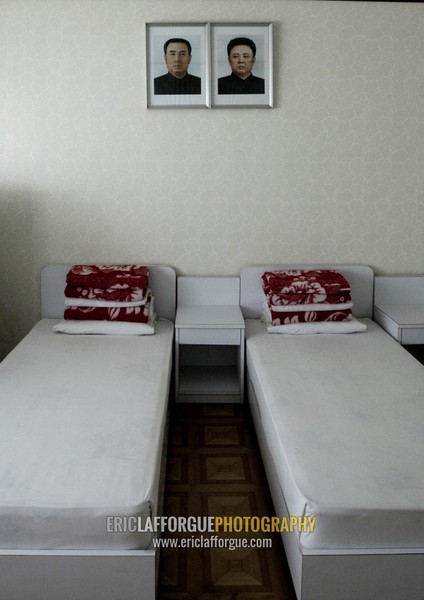 A bedroom in Songdowon international children's camp with the Dear Leaders portraits, Kangwon Province, Wonsan, North Korea