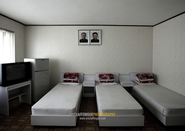 Bedroom with the official portraits of the Dear Leaders in Songdowon international children's camp, Kangwon Province, Wonsan, North Korea