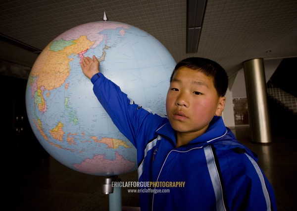 North Korean boy showing North Korea on a world map in Songdowon international children's camp, Kangwon Province, Wonsan, North Korea