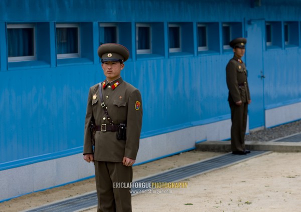 North Korean soldiers standing in front of the United Nations conference rooms on the demarcation line in the Demilitarized Zone, North Hwanghae Province, Panmunjom, North Korea