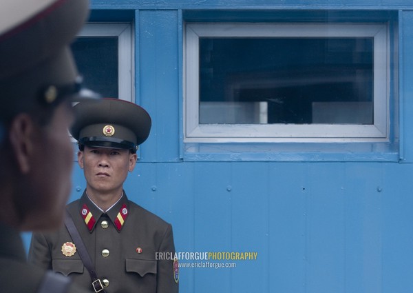 North Korean soldiers standing in front of the United Nations conference rooms on the demarcation line in the Demilitarized Zone, North Hwanghae Province, Panmunjom, North Korea