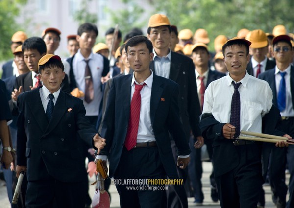 North Korean teenagers with yellow caps during the celebration of the 60th anniversary of the regim, Pyongan Province, Pyongyang, North Korea