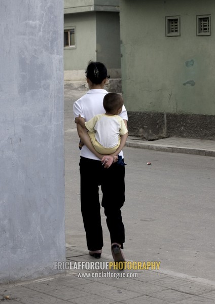 North Korean woman carrying her baby in her back, Pyongan Province, Pyongyang, North Korea