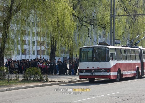 North Korean people queueing in the street to take a bus, Pyongan Province, Pyongyang, North Korea