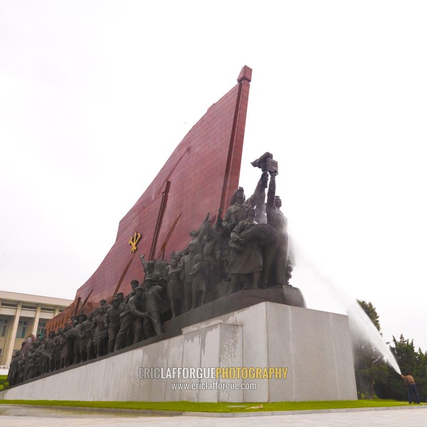 North Korean man cleaning the statues of North koreans in their anti-japanese revolutionary struggle in Mansudae Grand monument, Pyongan Province, Pyongyang, North Korea