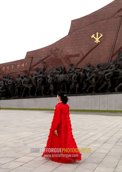 North Korean woman in red choson-ot in Mansudae Grand monument, Pyongan Province, Pyongyang, North Korea