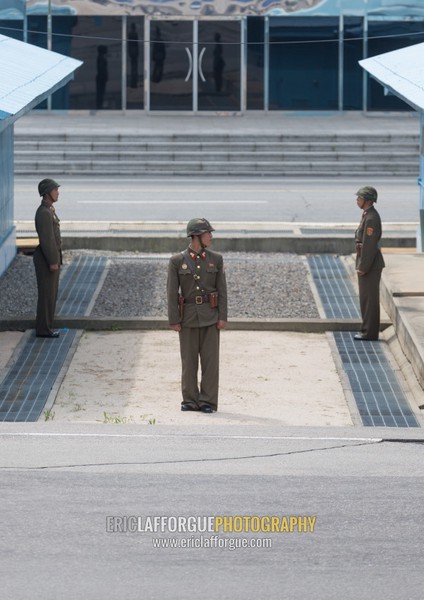 North Korean soldiers standing in front of the United Nations conference rooms on the demarcation line in the Demilitarized Zone, North Hwanghae Province, Panmunjom, North Korea