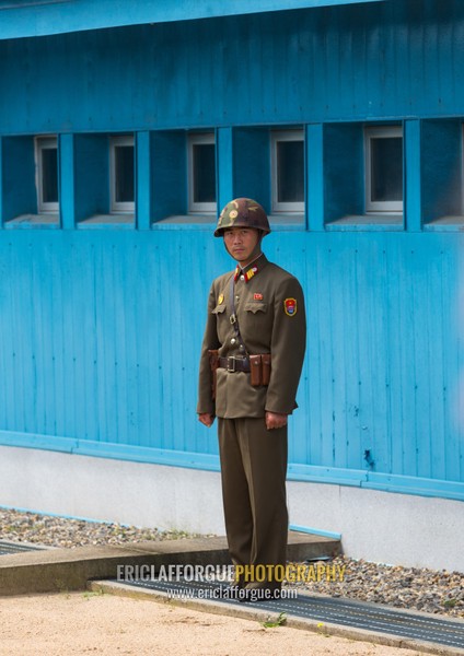 North Korean soldier standing in front of the United Nations conference rooms on the demarcation line in the Demilitarized Zone, North Hwanghae Province, Panmunjom, North Korea