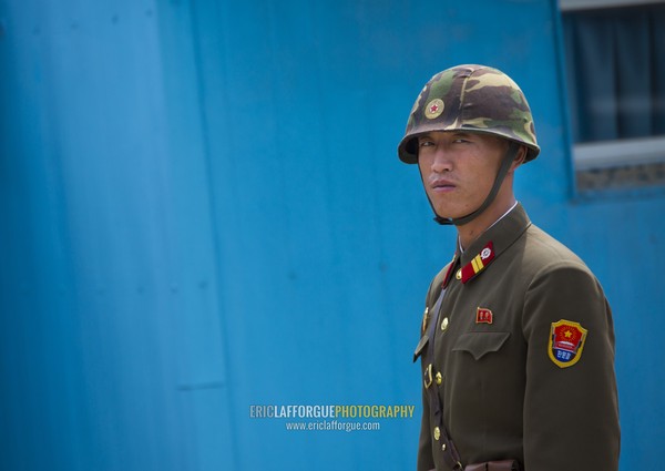 North Korean soldier wearing an helmet standing in front of the United Nations conference rooms on the demarcation line in the Demilitarized Zone, North Hwanghae Province, Panmunjom, North Korea