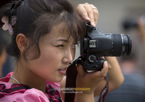 North Korean woman taking pictures, North Hwanghae Province, Kaesong, North Korea