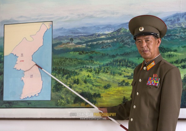 North Korean soldier in the joint security area in front of the map of Korea, North Hwanghae Province, Panmunjom, North Korea