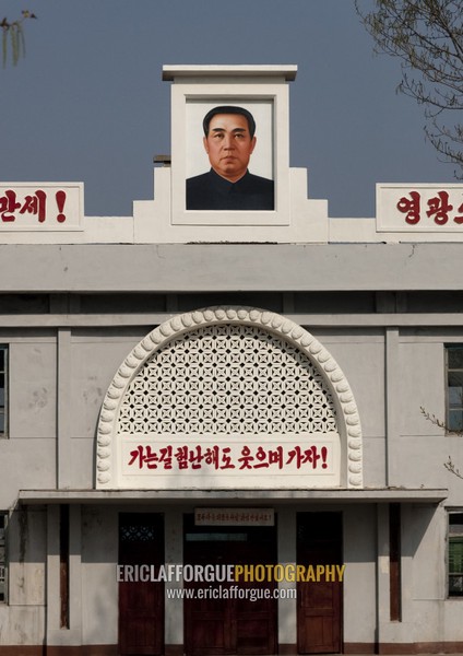 Kim il Sung portrait at the top of an official building, South Pyongan Province, Nampo, North Korea