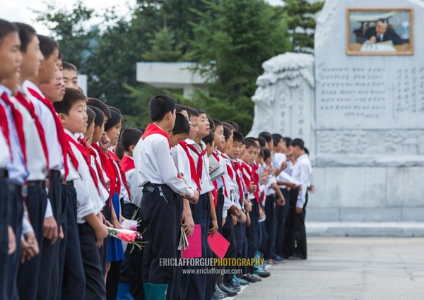 North Korean pioneers paying respect to the Leaders in Mansudae art studio, Pyongan Province, Pyongyang, North Korea