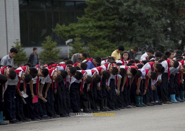 North Korean pioneers going to pay respect to the Dear Leaders at Mansudae art studio, Pyongan Province, Pyongyang, North Korea