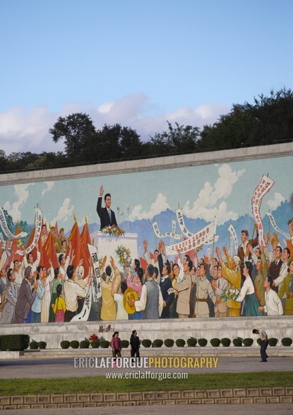 North Korean people passing in front of a giant Kim il Sung mosaic fresco, Pyongan Province, Pyongyang, North Korea