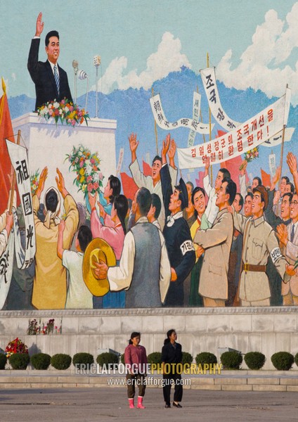 North Korean people passing in front of a giant Kim il Sung mosaic fresco, Pyongan Province, Pyongyang, North Korea