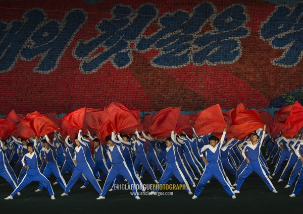 North Korean gymnasts with red flags during the Arirang mass games in may day stadium, Pyongan Province, Pyongyang, North Korea