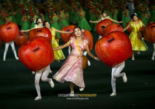 Women dancing between apples at Arirang mass games in may day stadium, Pyongan Province, Pyongyang, North Korea