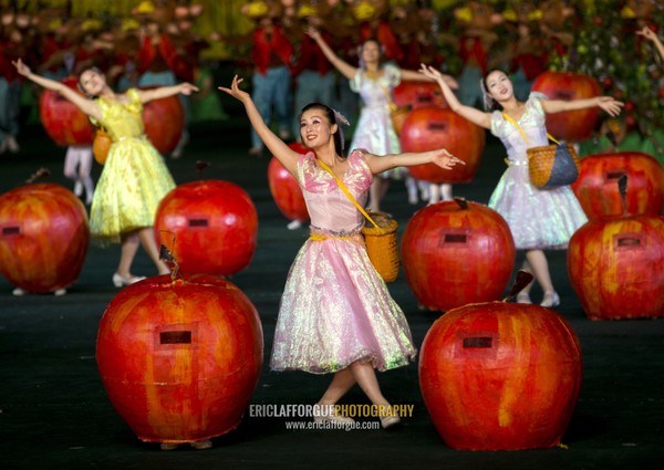 Women dancing between apples at Arirang mass games in may day stadium, Pyongan Province, Pyongyang, North Korea