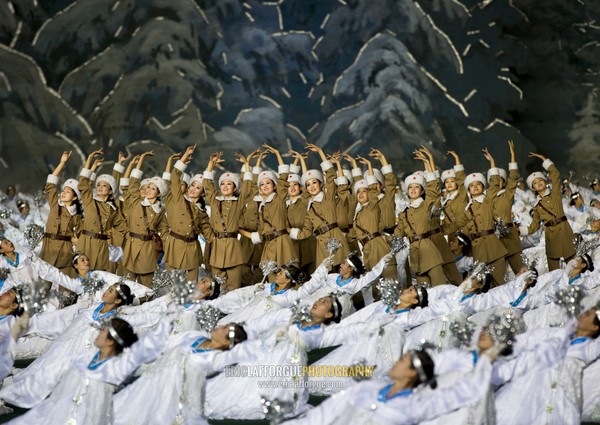 North Korean women dressed as soldiers and dancers in a forest during the Arirang mass games at may day stadium, Pyongan Province, Pyongyang, North Korea