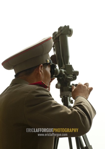 North Korean soldier looking south Korea with binoculars at the Demilitarized Zone, North Hwanghae Province, Panmunjom, North Korea