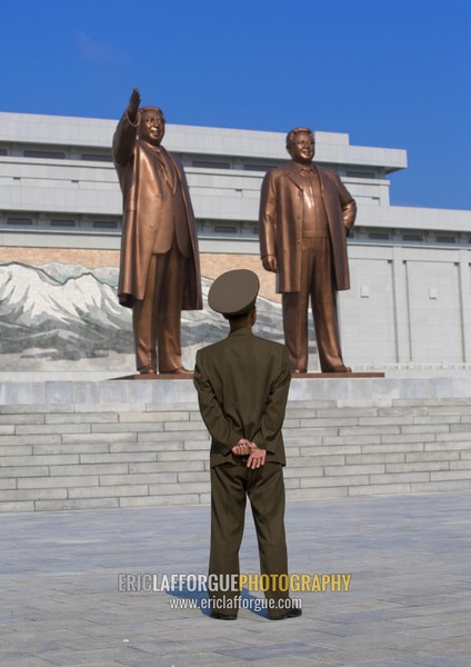 North kotrean soldier paying respect to the two statues of the Dear Leaders in the Grand monument on Mansu hill, Pyongan Province, Pyongyang, North Korea