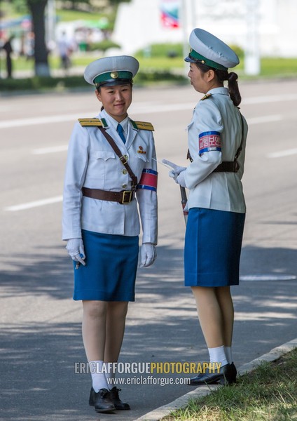 North Korean traffic security officers in white uniforms in the street, Pyongan Province, Pyongyang, North Korea