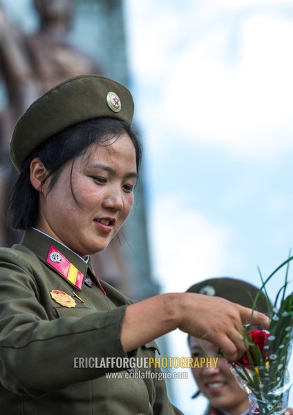 North Korean soldiers woman with flowers, Pyongan Province, Pyongyang, North Korea