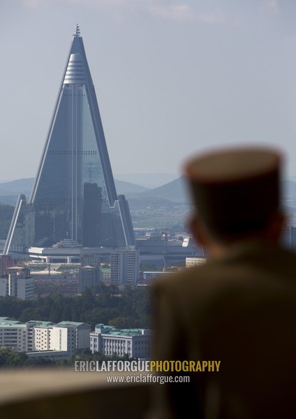 North Korean soldier watching Ryugyong hotel from the Juche tower, Pyongan Province, Pyongyang, North Korea