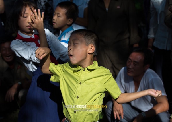 North Korean children dancing in a park on september 9 day of the foundation of the republic, Pyongan Province, Pyongyang, North Korea