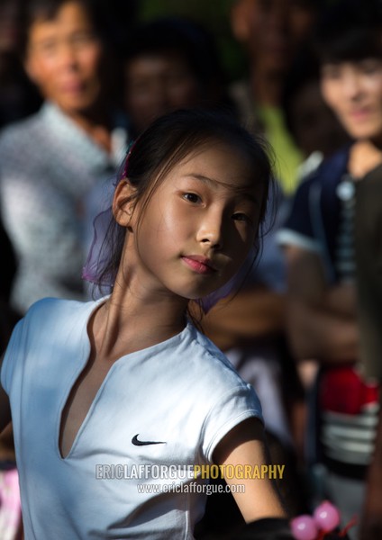 North Korean girl dancing in a park on september 9 day of the foundation of the republic, Pyongan Province, Pyongyang, North Korea