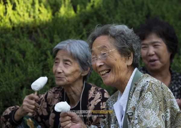 North Korean women eating ice creams in a park on september 9 day of the foundation of the republic, Pyongan Province, Pyongyang, North Korea