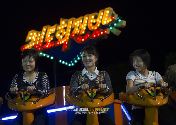 North Korean women in a fairground attraction at Kaeson youth park, Pyongan Province, Pyongyang, North Korea