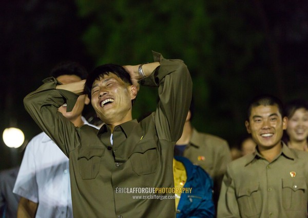 North Korean people laughing after a ride at Kaeson youth park fun fair, Pyongan Province, Pyongyang, North Korea