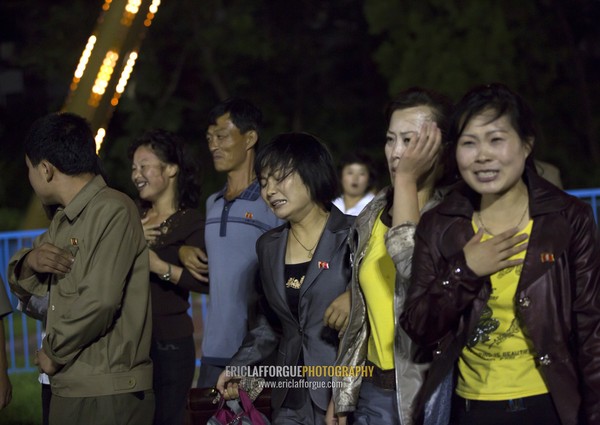 North Korean people with nausea coming down from a roller coaster in Kaeson youth park, Pyongan Province, Pyongyang, North Korea