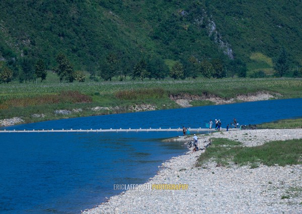 North Korean people crossing a river on a bridge, Pyongan Province, Pyongyang, North Korea