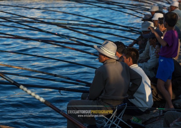 North Korean men fishing in the port, Kangwon Province, Wonsan, North Korea