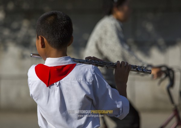 North Korean pioneer playing music in the street, Kangwon Province, Wonsan, North Korea