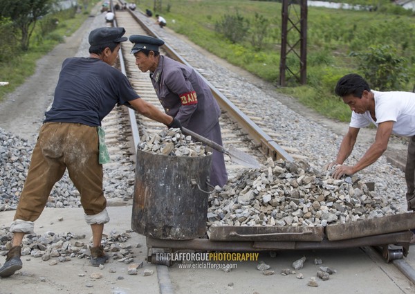 North Korean men working on empty railways, South Hamgyong Province, Hamhung, North Korea