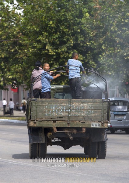 North Korean people on the back of a wood-burning steam truck in the street, South Hamgyong Province, Hamhung, North Korea