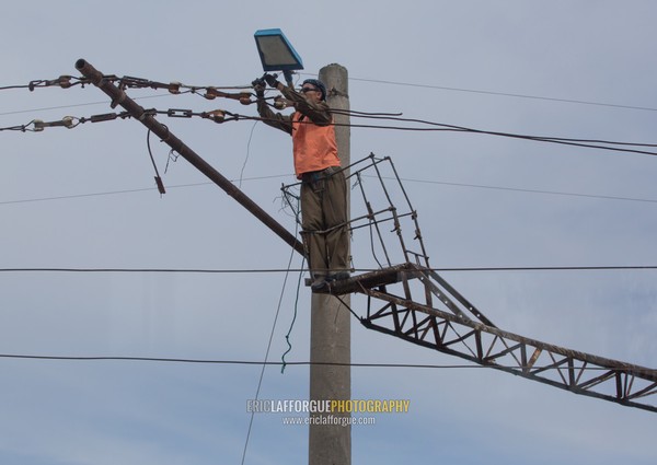 North Korean man repairing electric line, South Hamgyong Province, Hamhung, North Korea